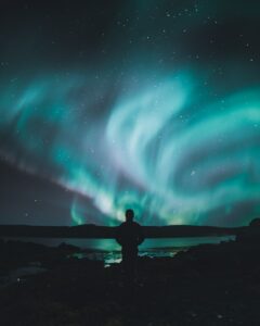 person standing on ground under sky lights